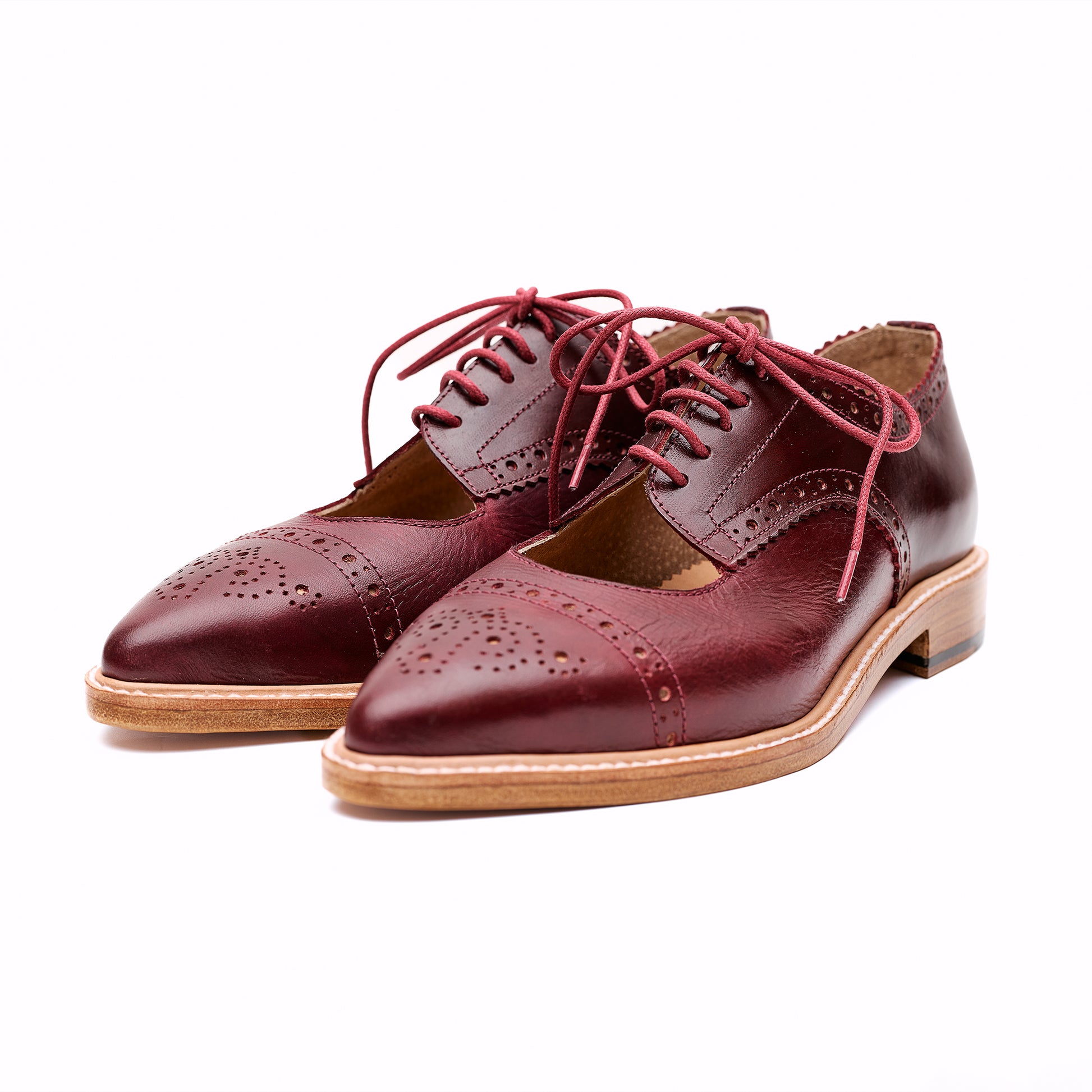 Burgundy brogue leather Derby shoes with cut-out detail.