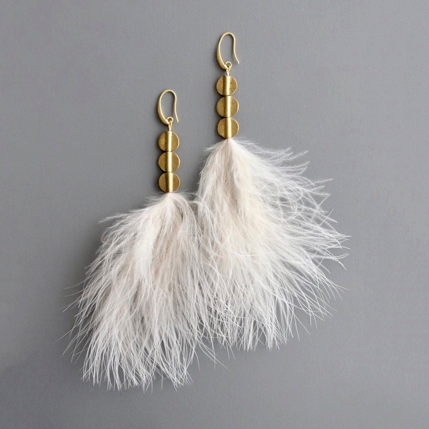 Blush feather and brass disc earrings