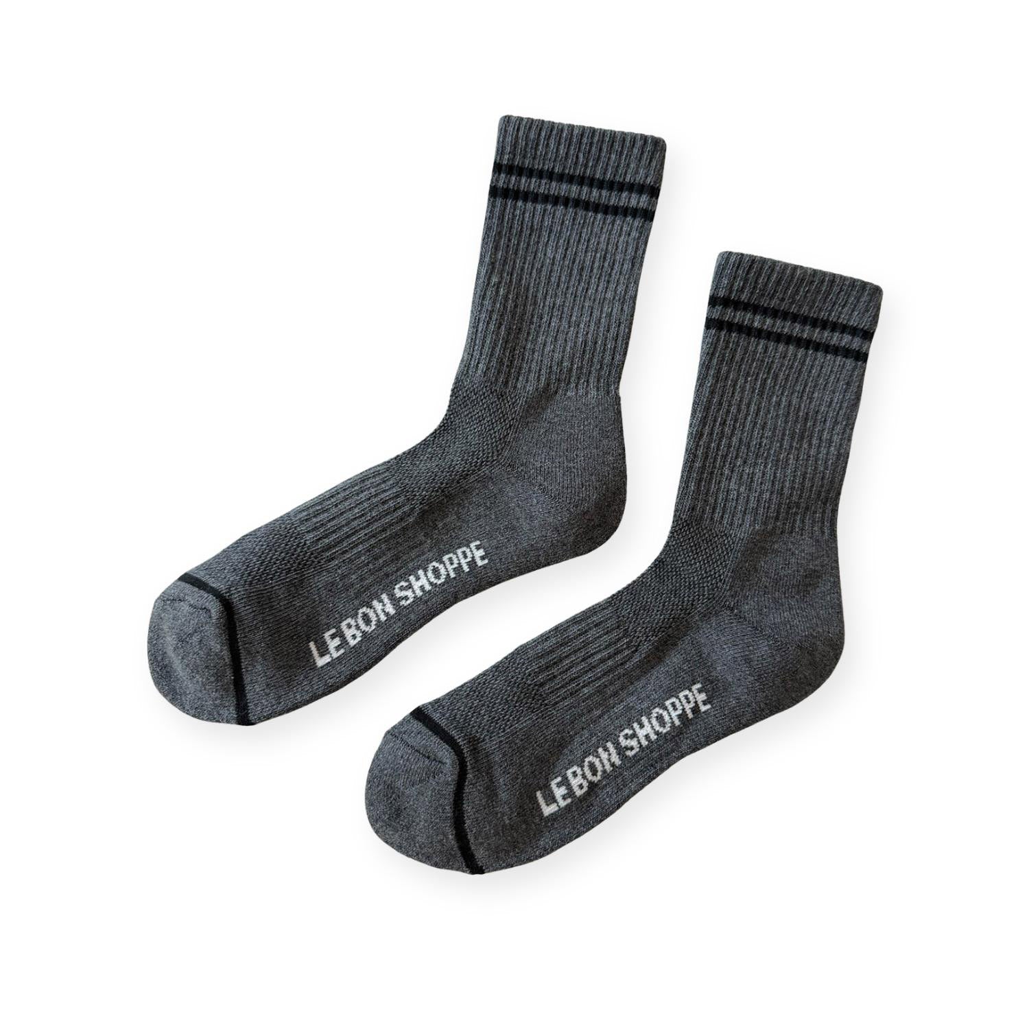 Pair of grey ribbed sport socks with double black stripe around ankle and "Le Bon Shoppe" on soul. 