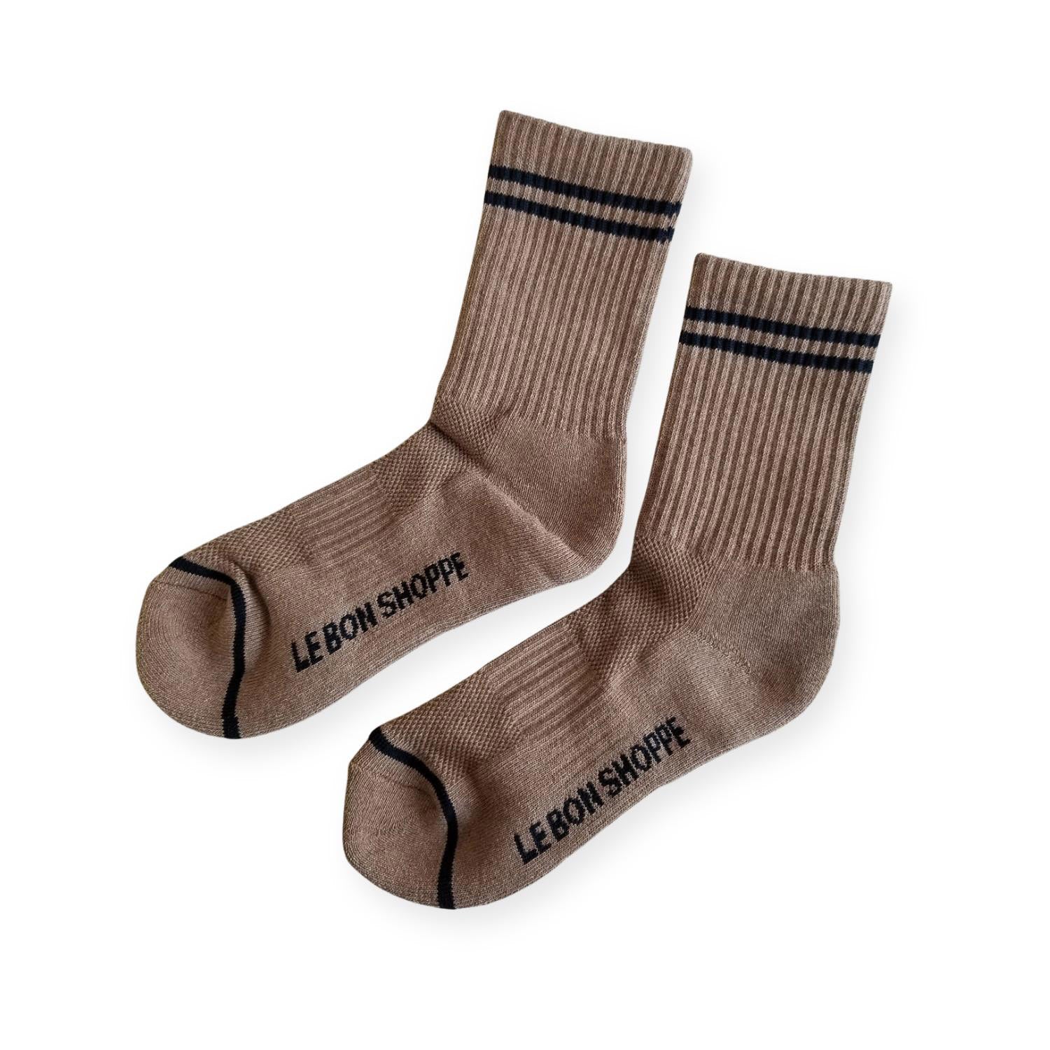Pair of brown ribbed sport socks with double black stripe around ankle and "Le Bon Shoppe" on soul. 