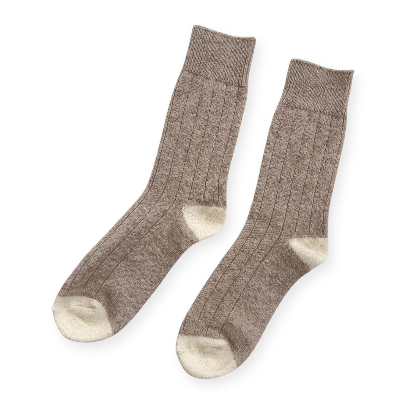 A pair of brown ribbed cashmere socks with white toes and heels. 