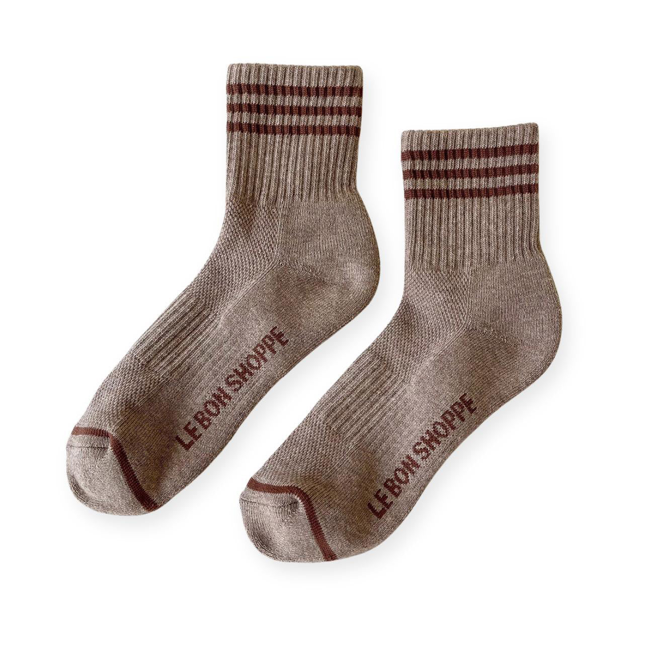 Pair of brown sport socks with dark brown stripes on ankle and Le Bon Shoppe text on soul. 