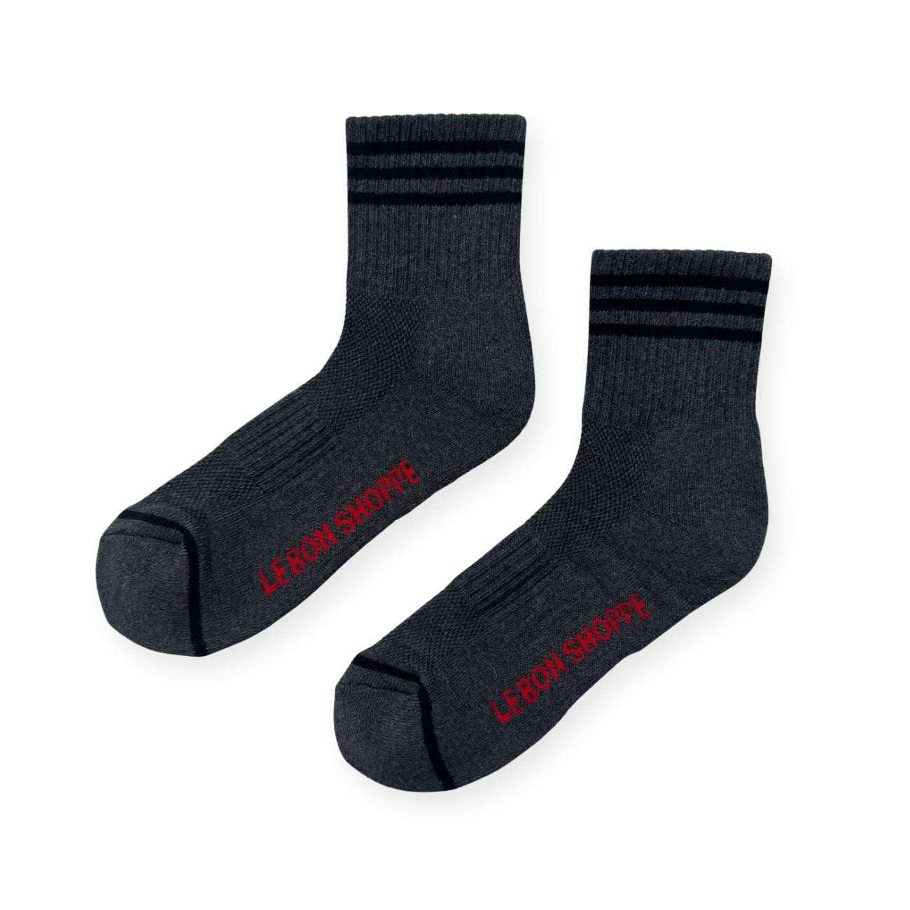 Pair of dark grey sport socks with black stripes on ankle and Le Bon Shoppe text on soul. 