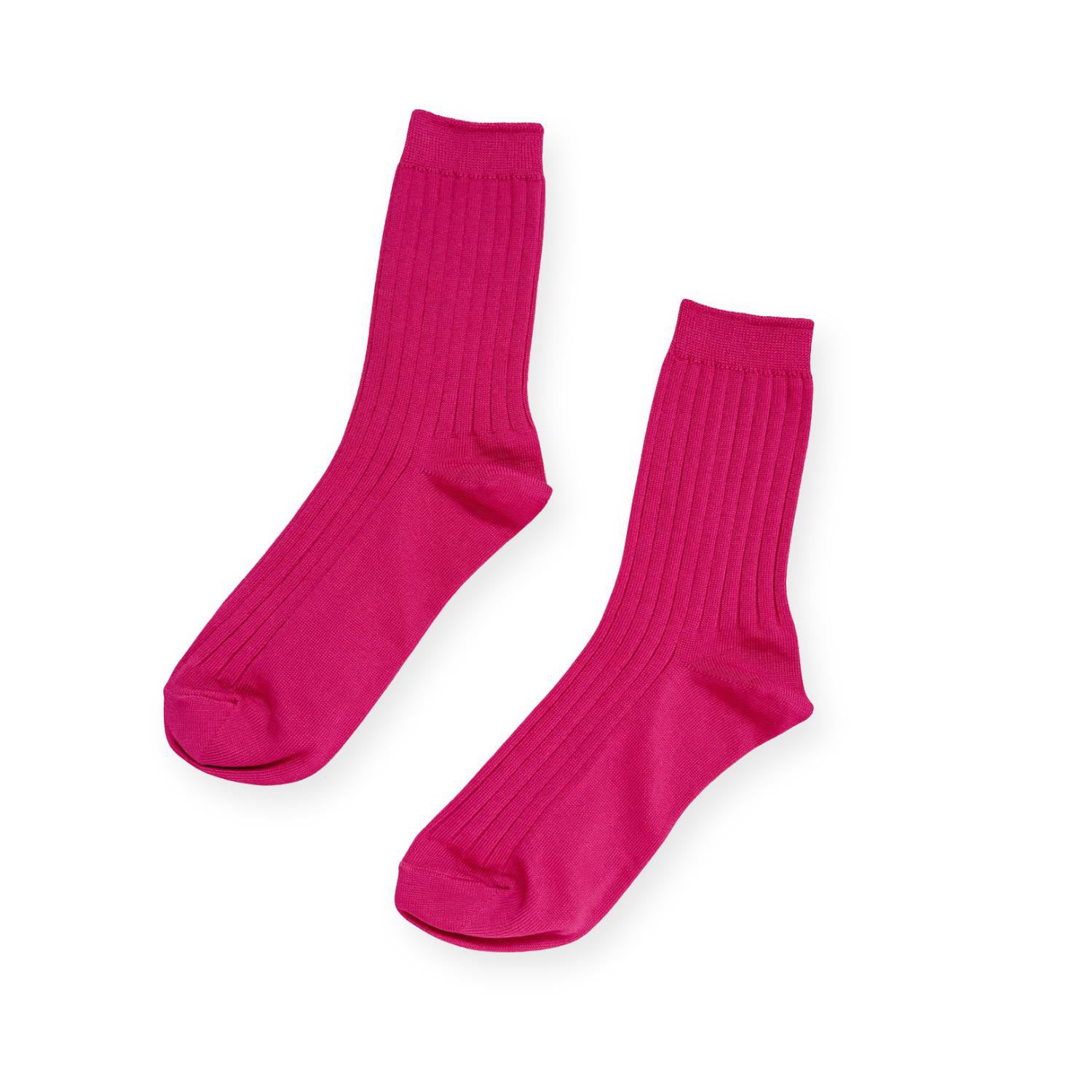 Pair of fuchsia ribbed socks on white background. 