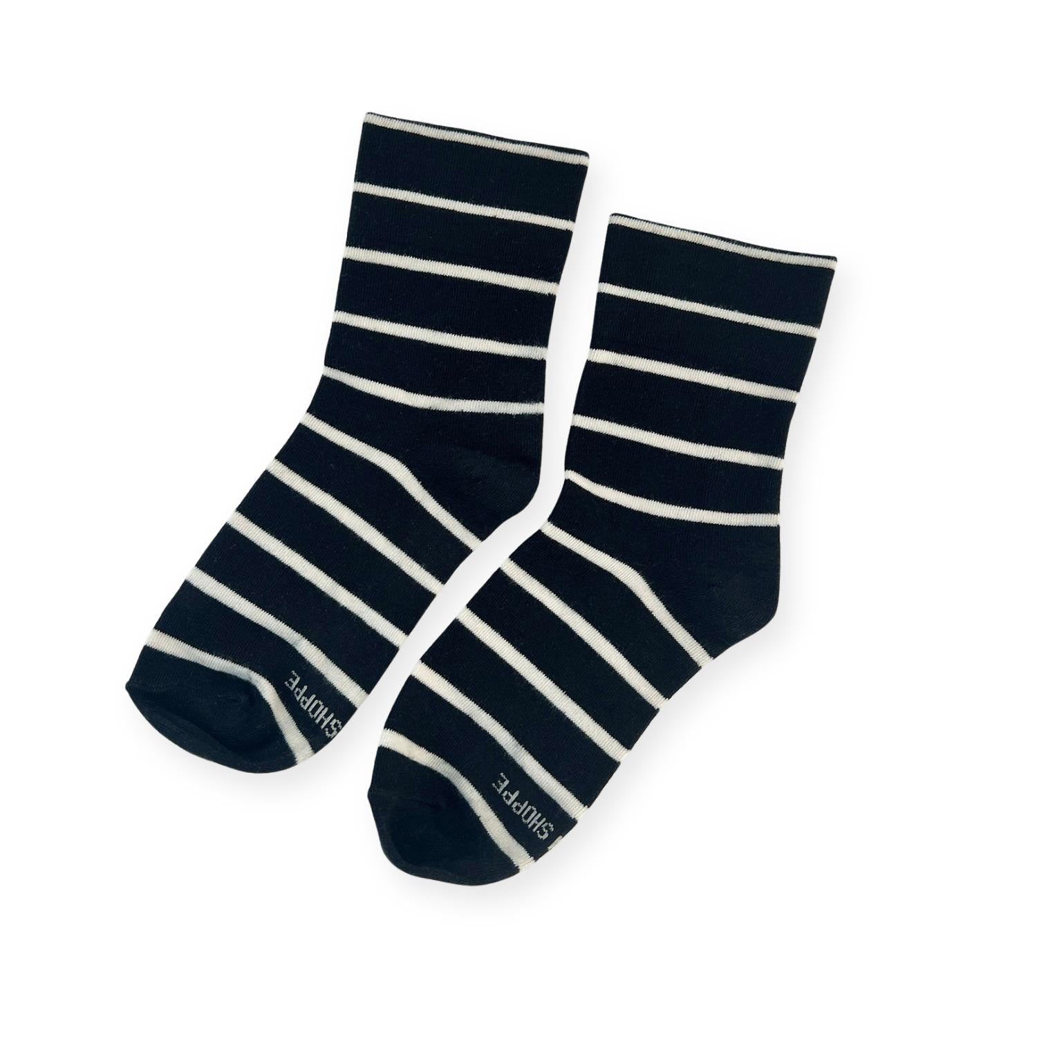 Pair of black and white stripe socks with Shoppe print on toe. 