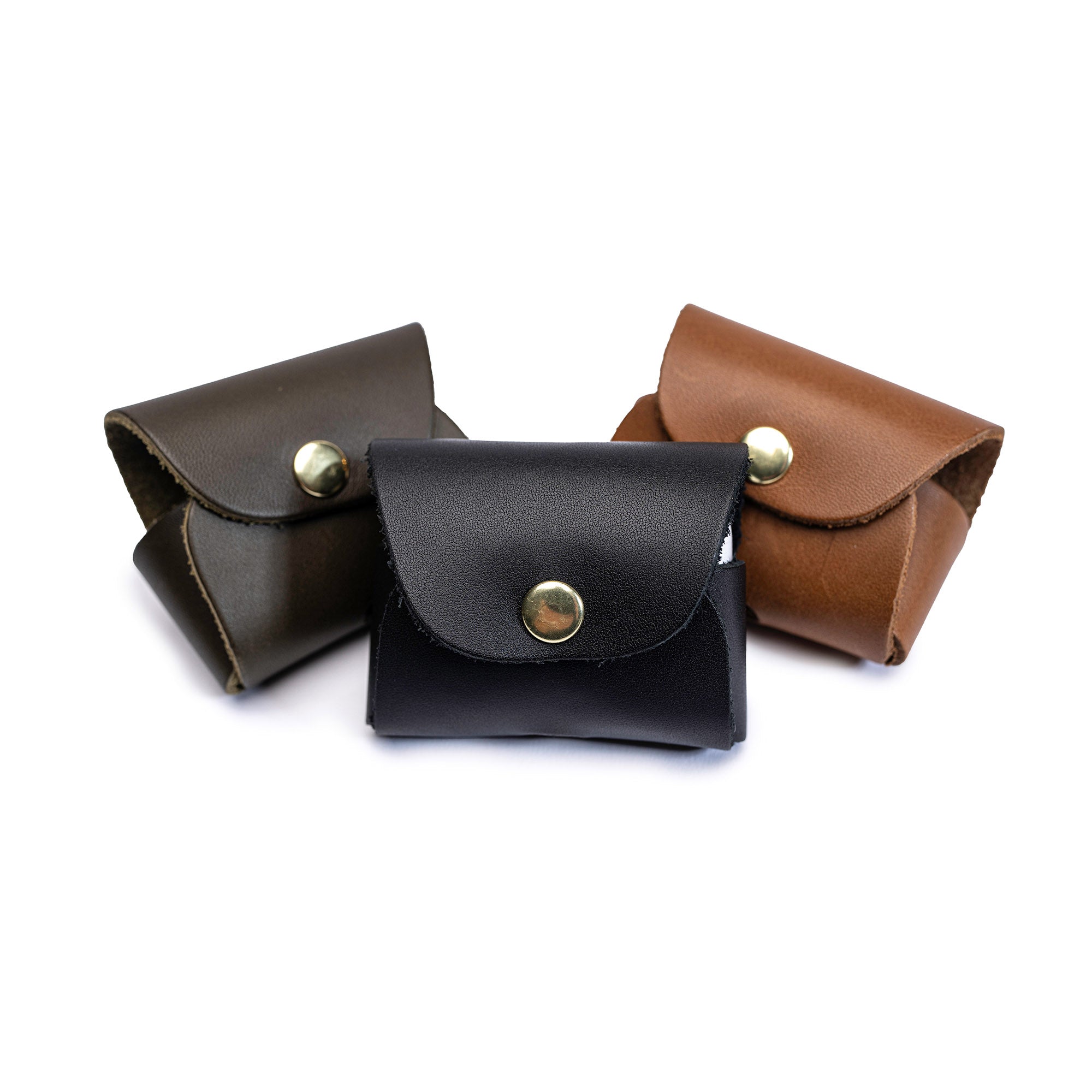 Three Leolo handmade leather ipod cases on white background - black, brown and cognac. 
