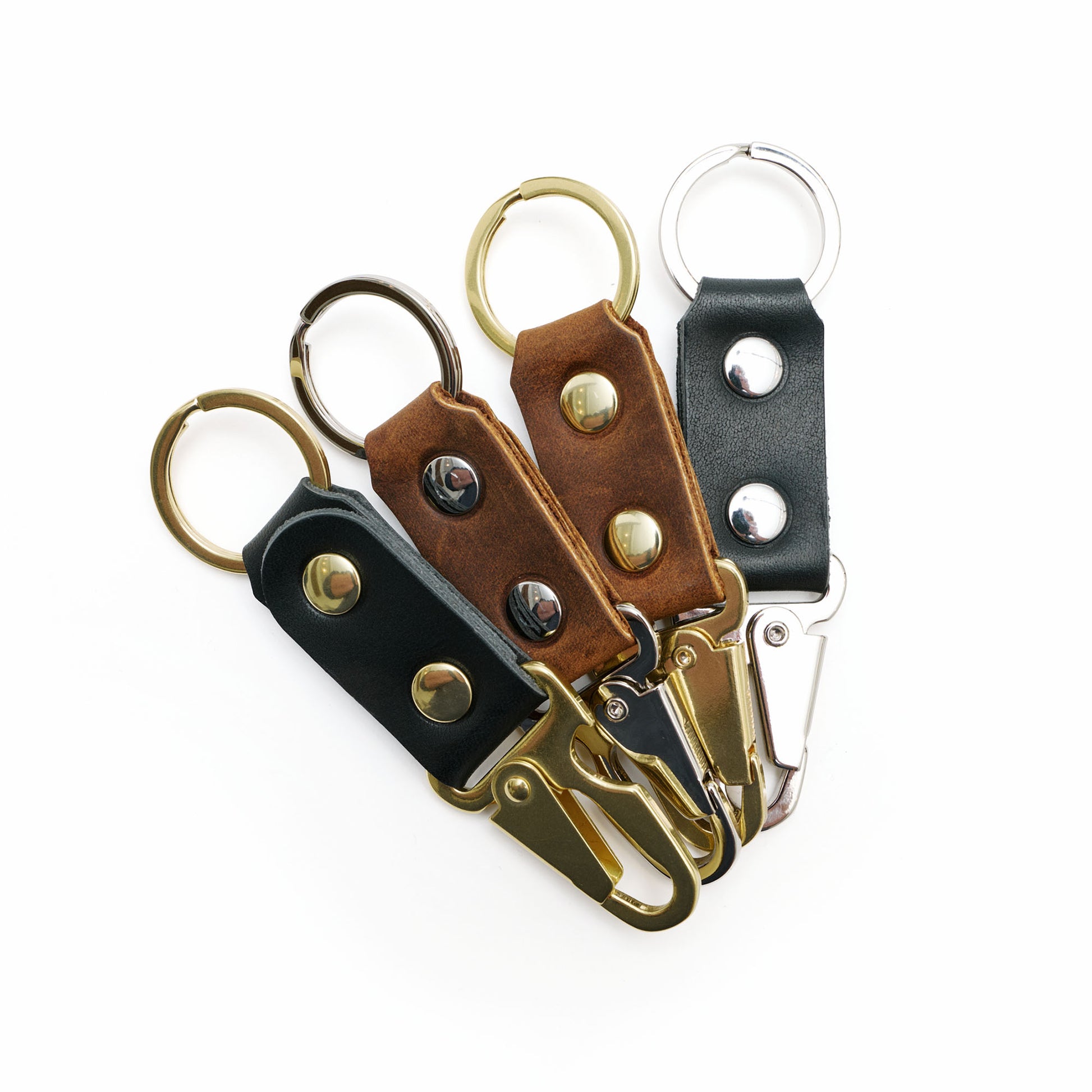 Four leather keychains on white background. 