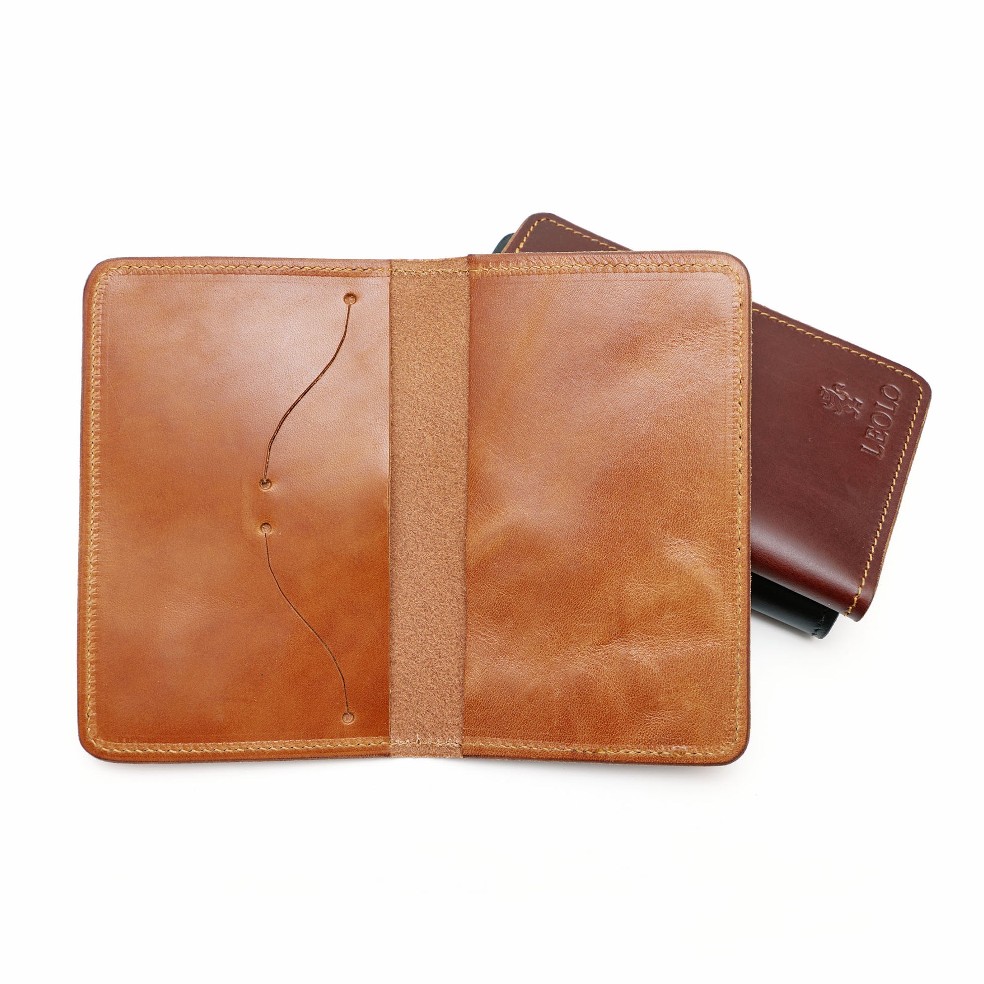 Three passport holders in front of white background with one open. 