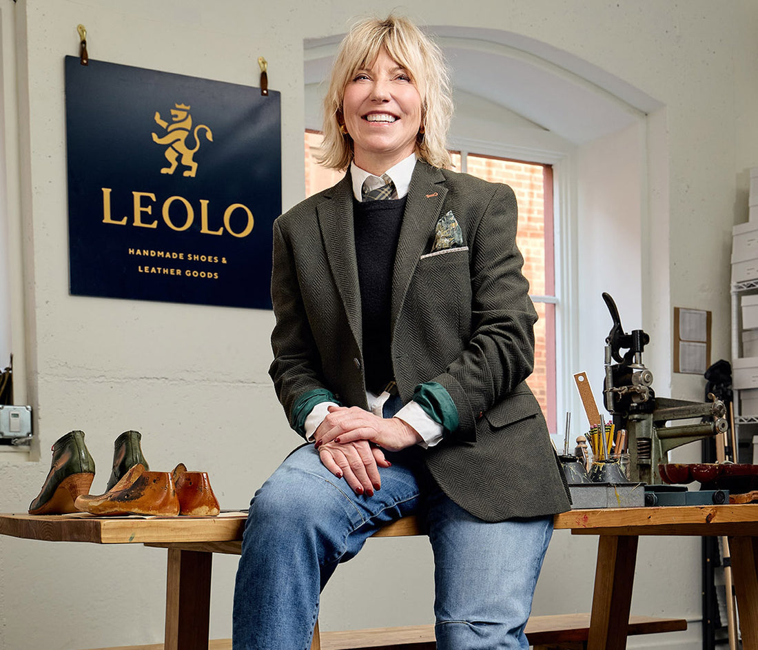 Person sitting on a table with shoes and a 'LEOLO' sign in the background