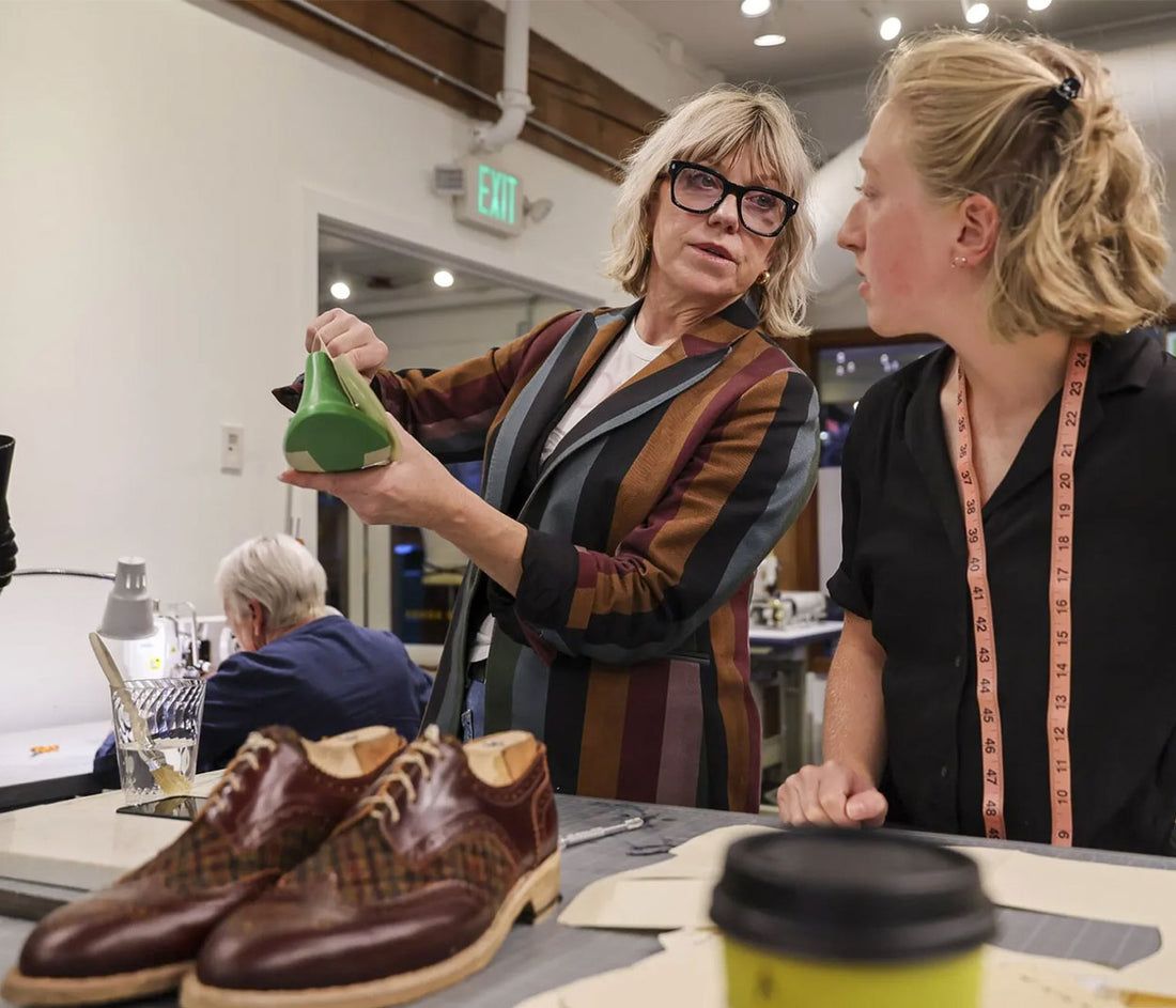 Shoemaker and staff in workshop. 