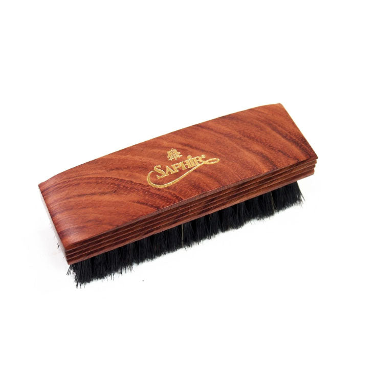 Beechwood shoe brush with black bristles and gold Saphir logo. 