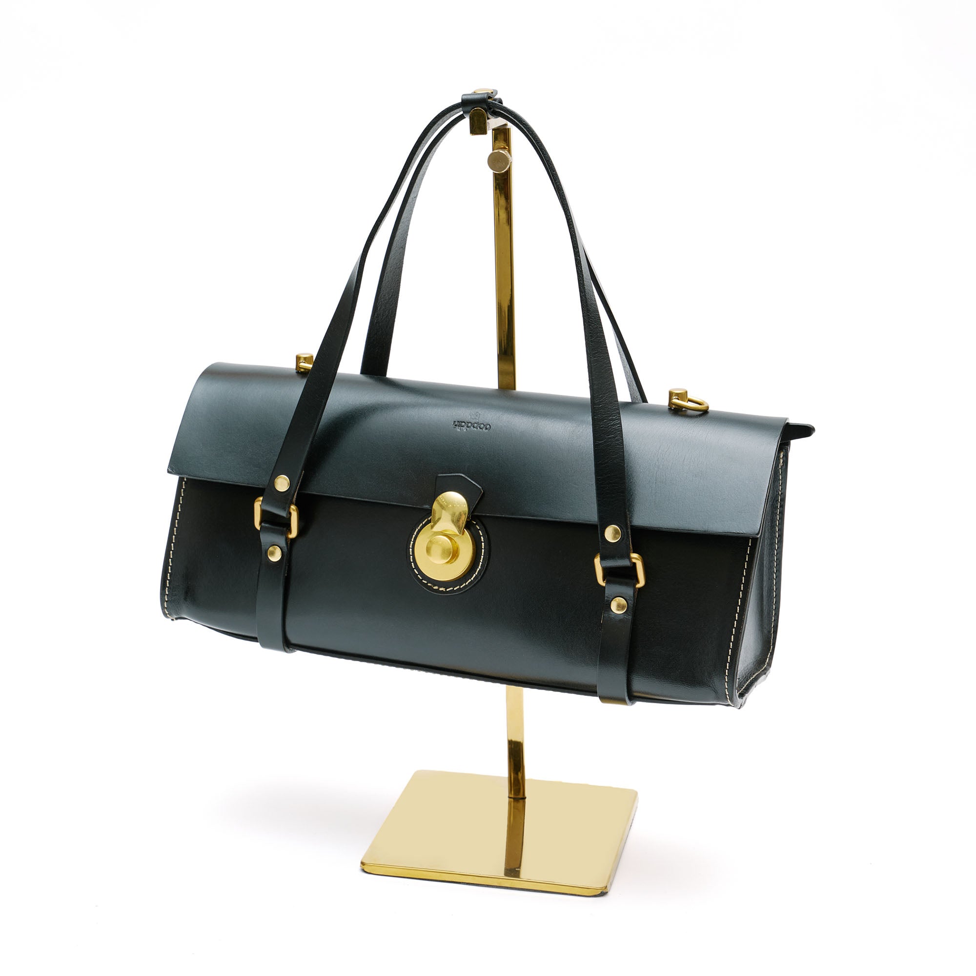 Black leather rectangle handbag with brass hardware. 