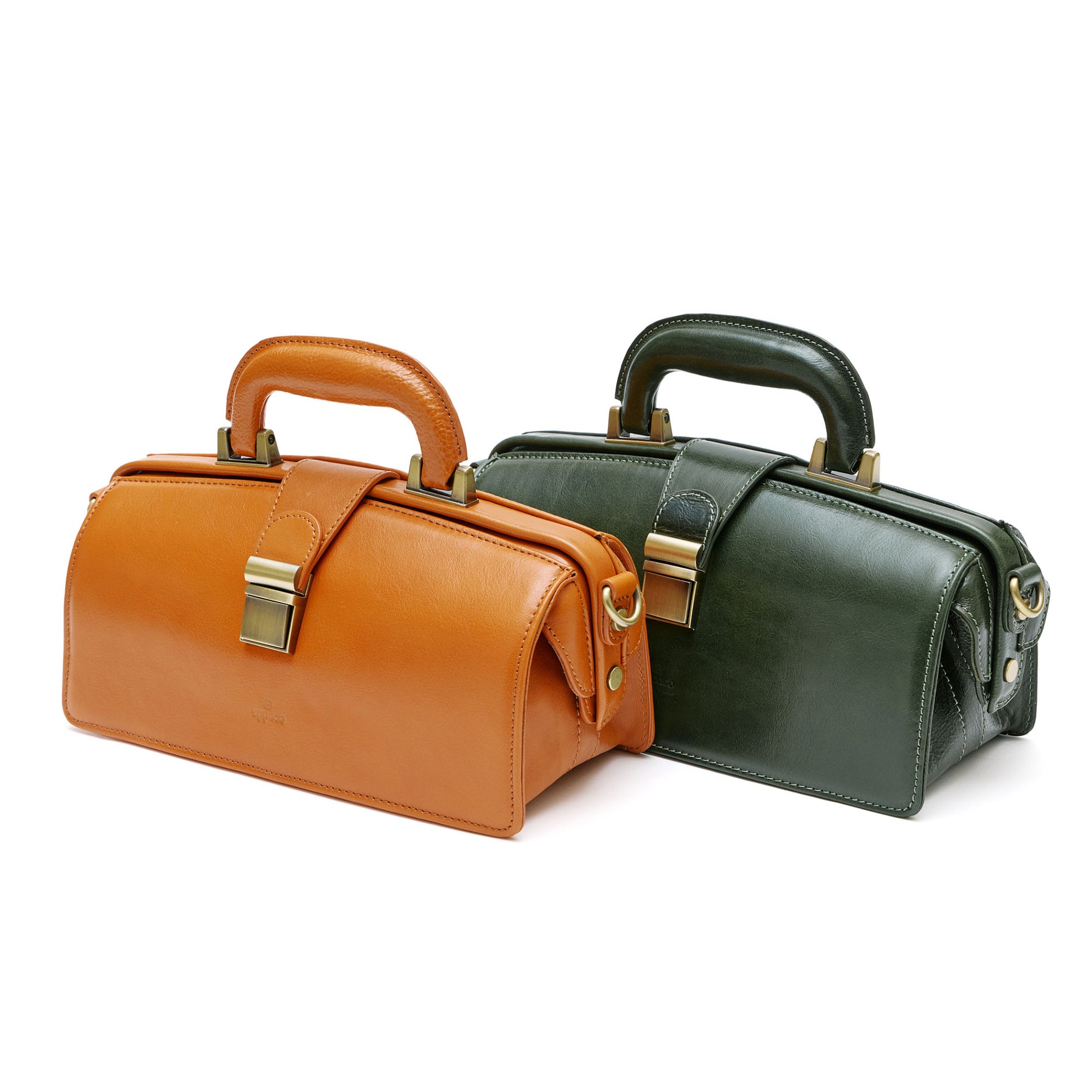 Two leather handbags, one orange, one green with bass hardware in front of white background. 
