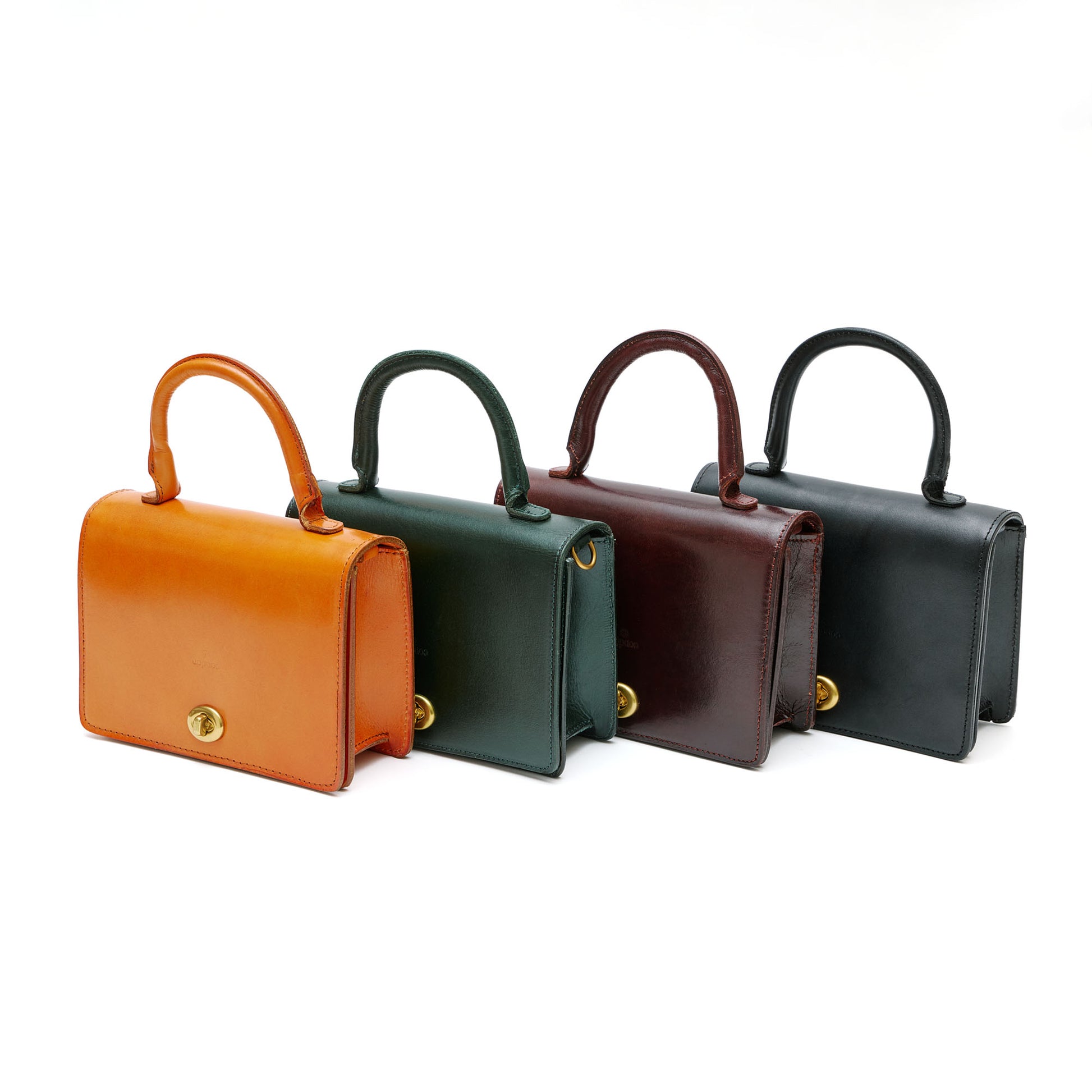Four leather mini satchell bags in chestnut, green, burgundy and black in front of white background. 
